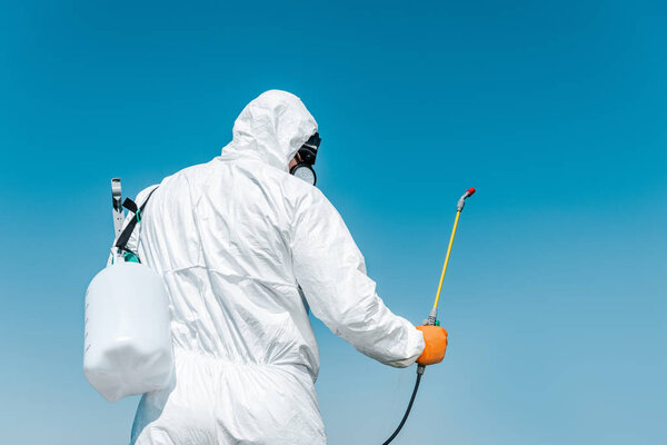 depositphotos_305956062 stock-photo-exterminator-white-protective-uniform-holding